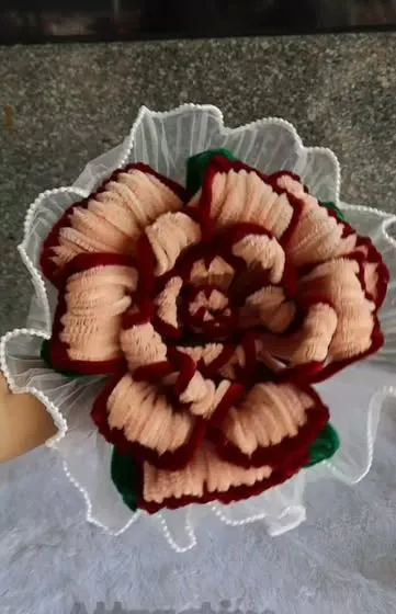 Ruffled peach and maroon chenille carnation